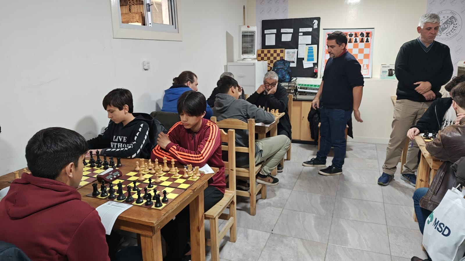El conjunto de Claypole albergó varias rondas este torneo. Aquí el presidente y secretario de nuestra federación observan atentamentes las partidas. 